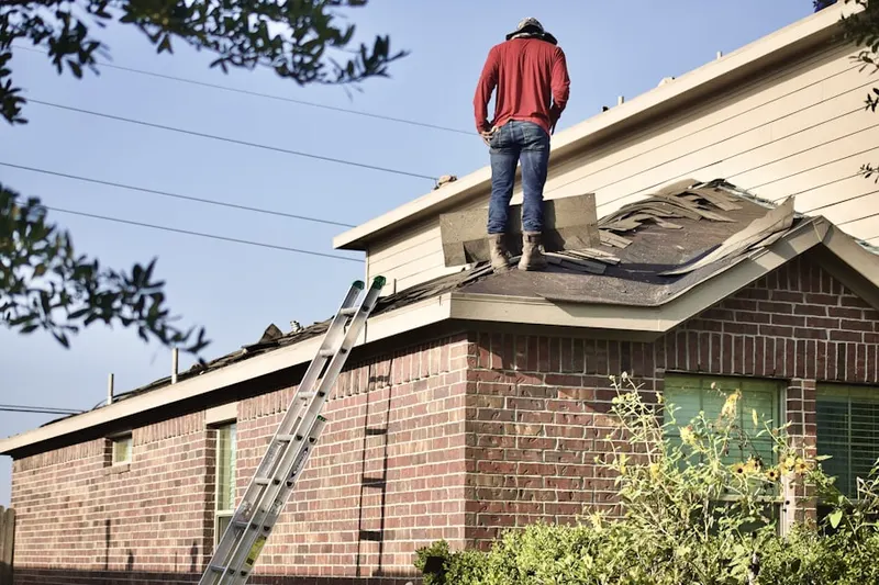 Professional roofer working on a residential roof in Waters Edge